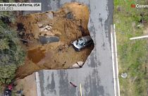 Cars in a California sinkhole caused by flooding