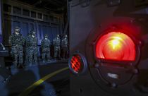 Soldiers stand guard on the Yushan-class landing platform dock during a military drill in Kaohsiung City, Taiwan.