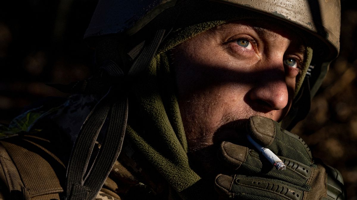A Ukrainian serviceman smokes a cigarette at his position at the frontline near Bakhmut, Donetsk region, Ukraine, Wednesday, Jan. 11, 2023.
