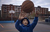A youth practices basketball in Husby district, Rinkeby-Kista borough in Stockholm, Sweden, Tuesday, April 28, 2020.