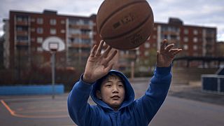 A youth practices basketball in Husby district, Rinkeby-Kista borough in Stockholm, Sweden, Tuesday, April 28, 2020. 
