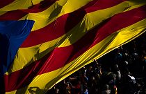 Protesters hold esteladas or independence flags as they take part in a demonstration during the Catalan National Day in Barcelona, Spain, Sunday, Sept. 11, 2022.
