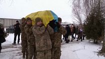Soldados ucranianos portan el féretro de su camarada fallecido Volodymyr Kerbut, Bucha, Ucrania, 12/1/2023