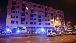 Patrol vehicles block a road at a residential building in Budapest, Hungary, late Thursday, 12 Jan. 2023.