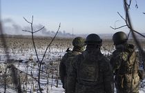 Des soldats ukrainiens regardent une explosion à Soledar, dans la région de Donetsk, Ukraine le 11 janvier 2023.