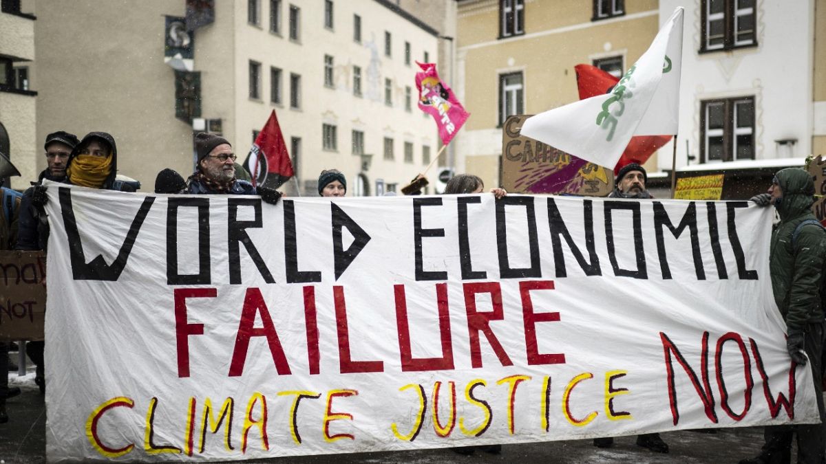 People attend a climate protest rally by Swiss party Juso and Strike WEF on the eve of the 52nd annual meeting of the World Economic Forum in Davos.