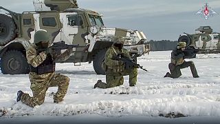 In a still from a video released by Russian Defense Ministry Press Service on 28 December 2022, Russian troops take part in drills at an unspecified location in Belarus. 