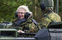 Christine Lambrecht, Minister of Defence, rides in a tank during her visit to the Tank Training Brigade 9 in Munster, Germany, Feb. 7, 2022. 