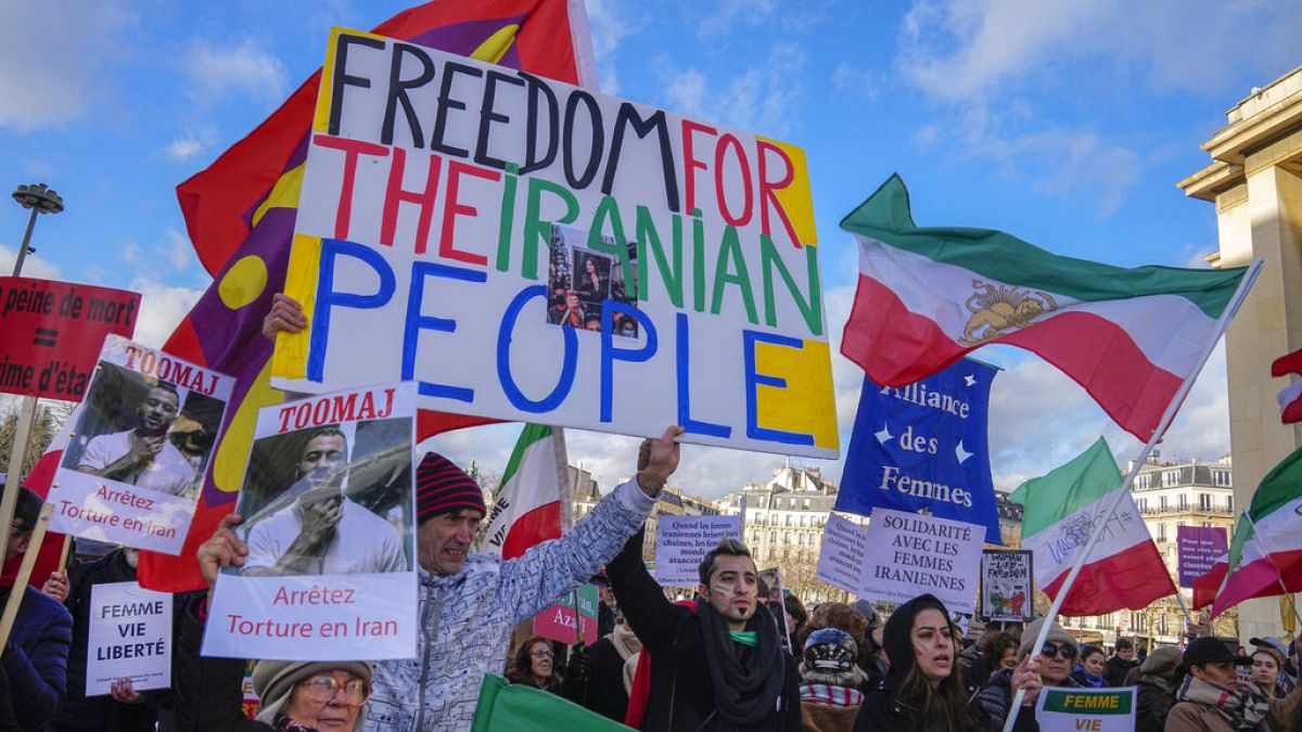 Protesters in Paris hold placards as they stage a demonstration at Trocadero Plaza in a show of solidarity for Iran's women on Sunday January 15, 2023