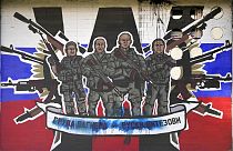 A mural depicting mercenaries of Russia's Wagner Group that reads: "Wagner Group - Russian knights" vandalised with paint on a wall in Belgrade, Serbia, Friday, Jan. 13, 2023.