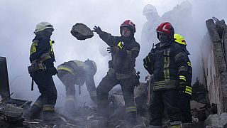 Rescue workers clear rubble from an apartment building which was destroyed by a Russian rocket attack at residential neighbourhood in the southeastern city of Dnipro, Ukraine.