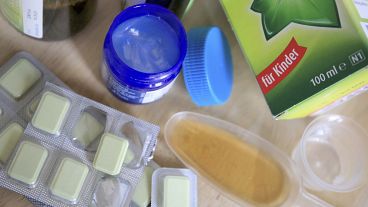 Medicines such as cough syrup, lozenges and ointment are seen on a table in an apartment in Berlin, Tuesday, December 20, 2022.