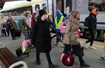 Refugees with children walk along a platform after fleeing the war from neighboring Ukraine at a railway station in Przemysl, Poland, on March 25, 2022.