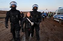 Police officers detain climate activist Greta Thunberg on the day of a protest against the expansion of the Garzweiler open-cast lignite mine.