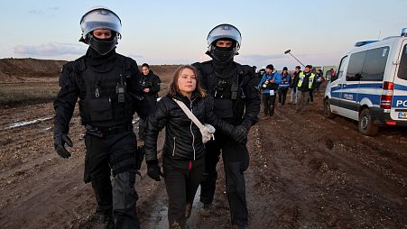 Police officers detain climate activist Greta Thunberg on the day of a protest against the expansion of the Garzweiler open-cast lignite mine.