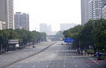Few cars are seen on the empty street in the recently locked down Haizhu district in Guangzhou in southern China's Guangdong province Friday, Nov. 11, 2022.