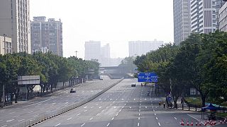 Few cars are seen on the empty street in the recently locked down Haizhu district in Guangzhou in southern China's Guangdong province Friday, Nov. 11, 2022.