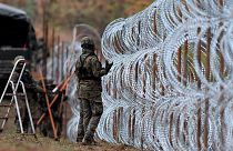 Polish soldiers begin laying a razor wire barrier along Poland’s border with the Russian exclave of Kaliningrad in Wisztyniec, Poland, on Nov. 2, 2022.