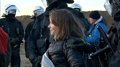 Greta Thunberg being led away by police