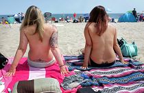 Women topless on the beach as they participate in the Free the Nipple global movement during Go Topless Day in 2017