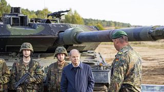 German Chancellor Olaf Scholz talks to German soldiers at a "Leopard 2" main battle tank during a training and instruction exercise, Ostenholz, Germany