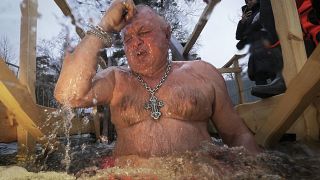 A Russian Orthodox worshipper dips into the icy water during a traditional Epiphany celebration in St. Petersburg, Russia.