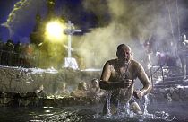 A man bathes in water during a traditional Epiphany celebration as the temperature dropped to about -12 degrees near the Achairsky monastery in Russia.