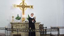 FILE: Evangelical Lutheran Church of Denmark priest conducting a service
