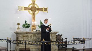 FILE: Evangelical Lutheran Church of Denmark priest conducting a service