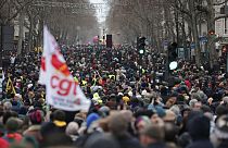 Protestors march during a demonstration against pension changes.