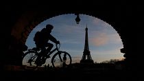 A cyclist rides on the Pont de Bir-Hakeim bridge during nationwide strike against French government's pension reform plan in France, 19 January 2023.