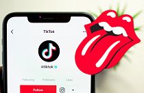 Rolling Stones logo and the TikTok app on a phone