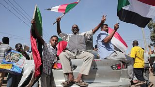 Sudanese demonstrators march in Khartoum to protest a deal signed between the country's main pro-democracy group and its ruling generals, who seized power in October