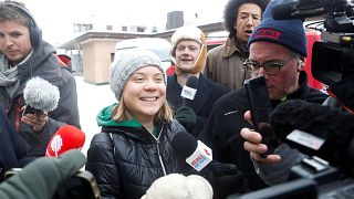 Climate activist Greta Thunberg reacts as she walks with members of the media during the World Economic Forum in Davos (WEF) in Davos, Switzerland