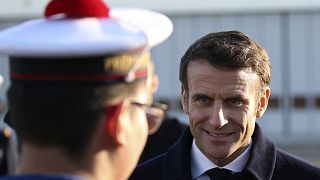 French President Emmanuel Macron smiles to a navy soldier as he visits the Mont-de-Marsan air base, southwestern, Friday, 20 Jan 2023