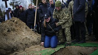 Anya Korostenska drops to her knees at the grave of her fiance Oleksiy Zavadskyi, a Ukrainian serviceman who died in combat on January 15 in Bakhmut.