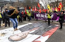 FILE - a protester jumping on a banner with the image of Turkish President during a demonstration organised by The Kurdish Democratic Society Center in Sweden, January 21