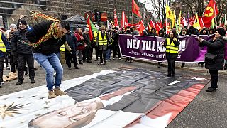 FILE - a protester jumping on a banner with the image of Turkish President during a demonstration organised by The Kurdish Democratic Society Center in Sweden, January 21