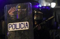 Spanish National Police forces stand guard outside their headquarters in Barcelona during a demonstration in support of Spanish rapper Pablo Hasel on February 22, 2021.