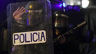 Spanish National Police forces stand guard outside their headquarters in Barcelona during a demonstration in support of Spanish rapper Pablo Hasel on February 22, 2021.