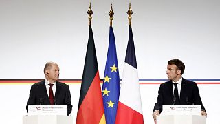 German Chancellor Olaf Scholz and French President Emmanuel Macron attend a joint press conference.