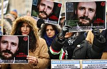 Demonstrators held up photos of Olivier Vandecasteele at rally in Brussels.
