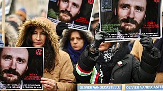 Demonstrators held up photos of Olivier Vandecasteele at rally in Brussels.