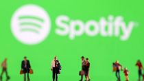 Small figurines displayed in front of the Spotify logo, February 11, 2022. 