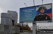 A poster displaying a Russian soldier with a slogan reading 'Glory to the Heroes of Russia' near the 'PMC Wagner Centre' in Saint Petersburg