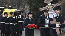 Ukrainian servicemen carry coffins covered with the national flags during the funeral ceremony of Ukraine's Interior Minister Denys Monastyrsky in Kyiv, 21 January 2023