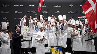الشيف الدنماركي براين هانسن (وسط)، يحتفل مع أعضاء فريقه بعد فوزه في مسابقة "بوكوز الذهبي"، ليون فرنسا 23 يناير 2023.