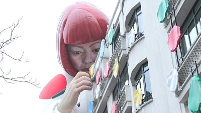 The installation of Japanese artist Yayoi Kusama, peering over the Louis Vuitton flagship store is pictured at the Champs-Élysées avenue in Paris, Sunday, Jan. 15, 2023.