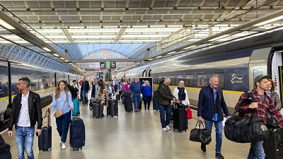 Travelers at St. Pancras International train station board the high speed Eurostar train to Paris, in London, Saturday, May 21, 2022.