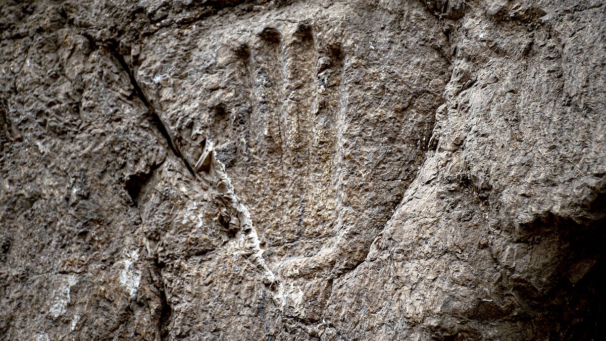 علماء آثار اسرائيليون يعثرون على نقش لكف يد على جدار حجري صخري في خندق مائي قديم خارج سور البلدة القديمة في القدس الشرقية المحتلة، 25 يناير 2023.